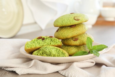 Photo of Delicious mint chocolate chip cookies on wooden table, closeup