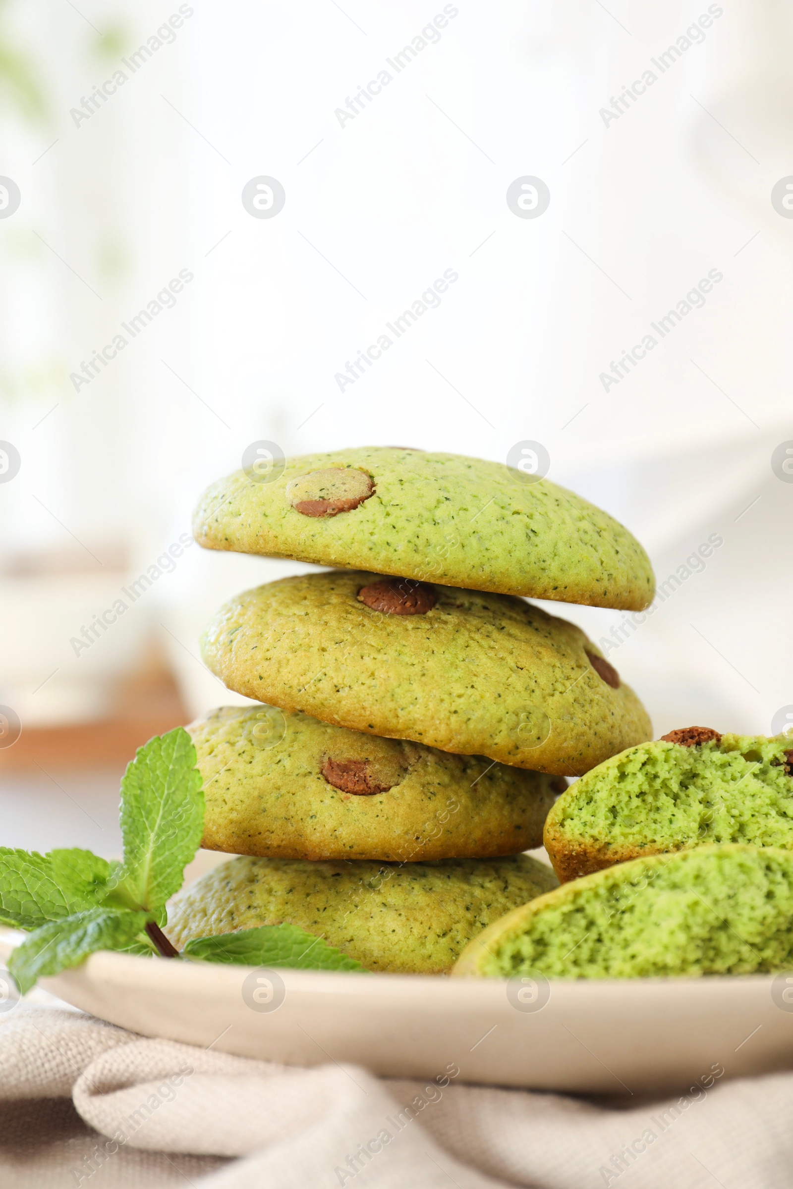 Photo of Delicious mint chocolate chip cookies on table, closeup