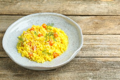 Photo of Delicious pumpkin risotto on wooden table, closeup