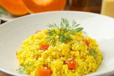 Photo of Delicious pumpkin risotto with dill in bowl, closeup