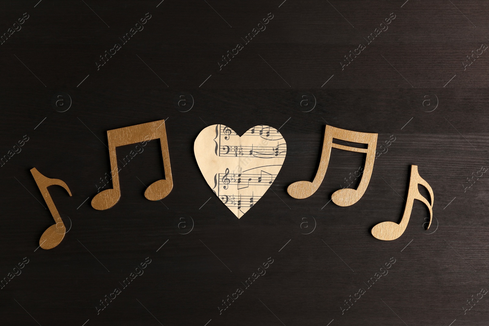 Photo of Paper heart and notes on black wooden table, flat lay