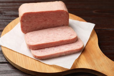 Photo of Tasty canned meat on wooden table, closeup