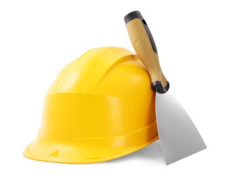 Photo of Hardhat and putty knife isolated on white. Construction tool