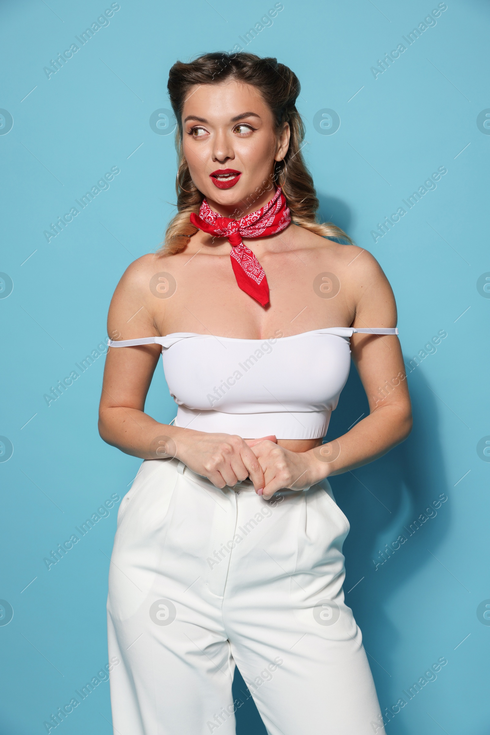 Photo of Attractive pin-up woman on light blue background