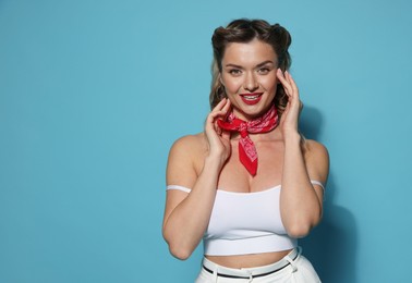 Photo of Happy pin-up woman on light blue background, space for text