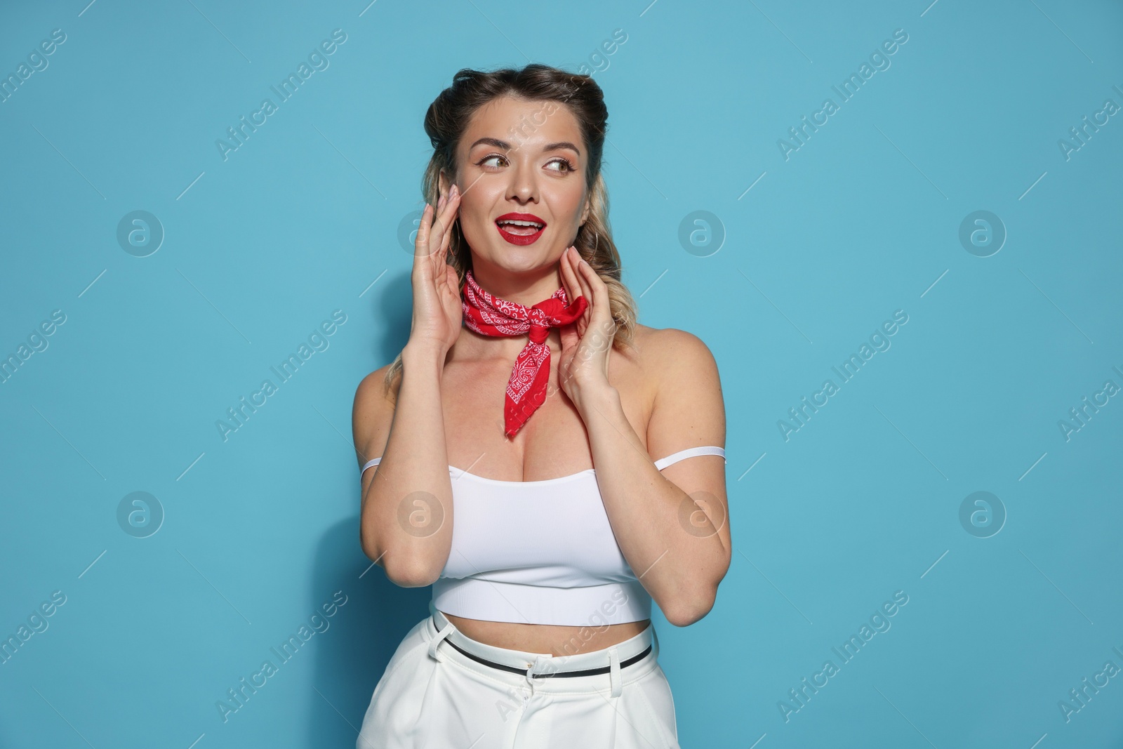 Photo of Attractive pin-up woman on light blue background