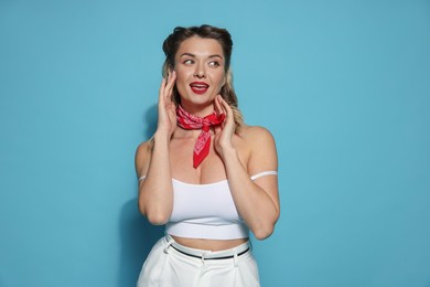 Photo of Attractive pin-up woman on light blue background