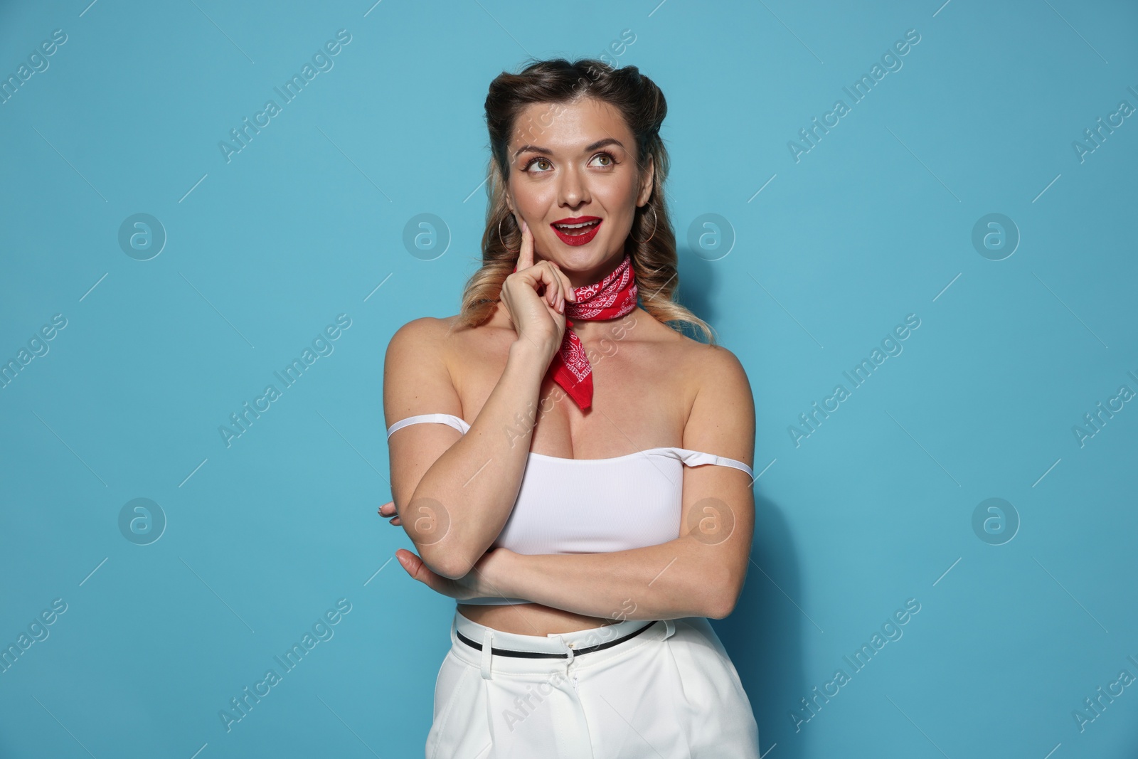 Photo of Attractive pin-up woman on light blue background