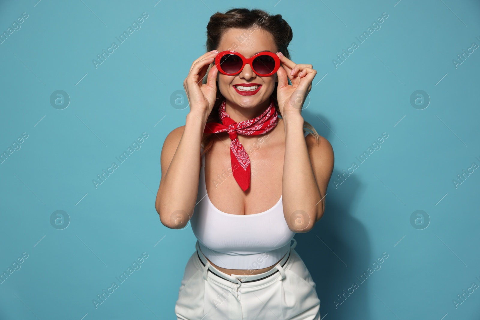 Photo of Happy pin-up woman on light blue background