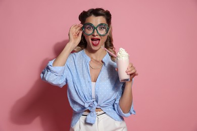 Photo of Excited pin-up woman with milk shake on pink background