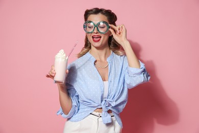 Photo of Happy pin-up woman with milk shake on pink background