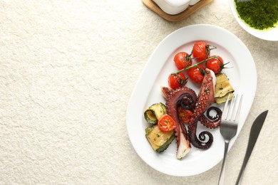 Photo of Fried octopus with herb sauce, zucchini and tomatoes on light textured table, flat lay. Space for text