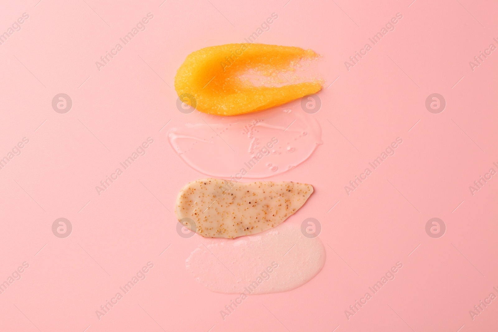 Photo of Samples of cosmetic products on pink background, top view. Skin care