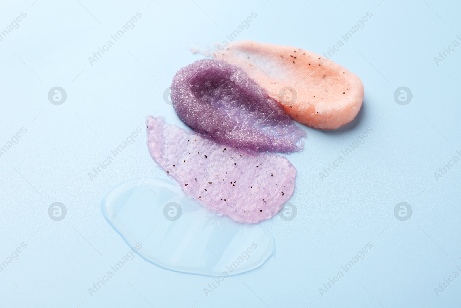 Photo of Samples of cosmetic products on light blue background. Skin care