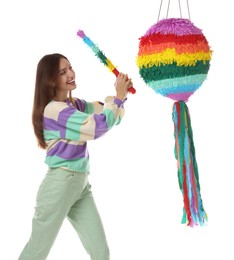 Photo of Happy woman breaking colorful pinata with stick on white background