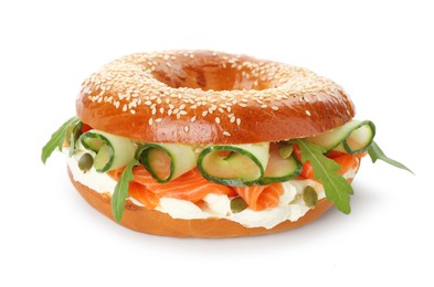 Photo of Delicious bagel with salmon, cream cheese and cucumber isolated on white