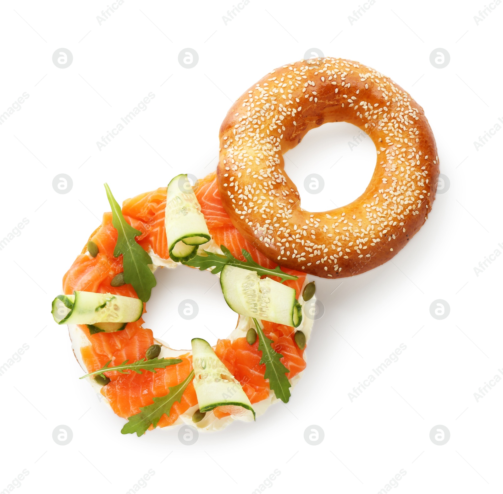 Photo of Delicious bagel with salmon, cream cheese and cucumber isolated on white, top view