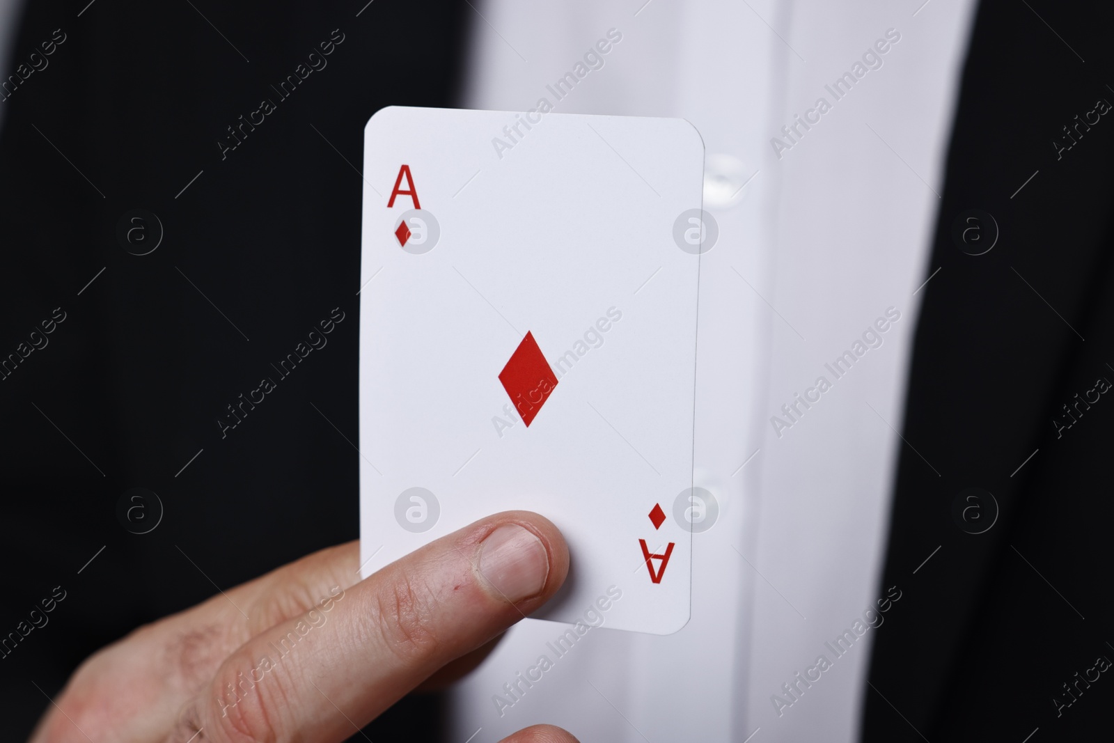 Photo of Professional illusionist with one playing card, closeup