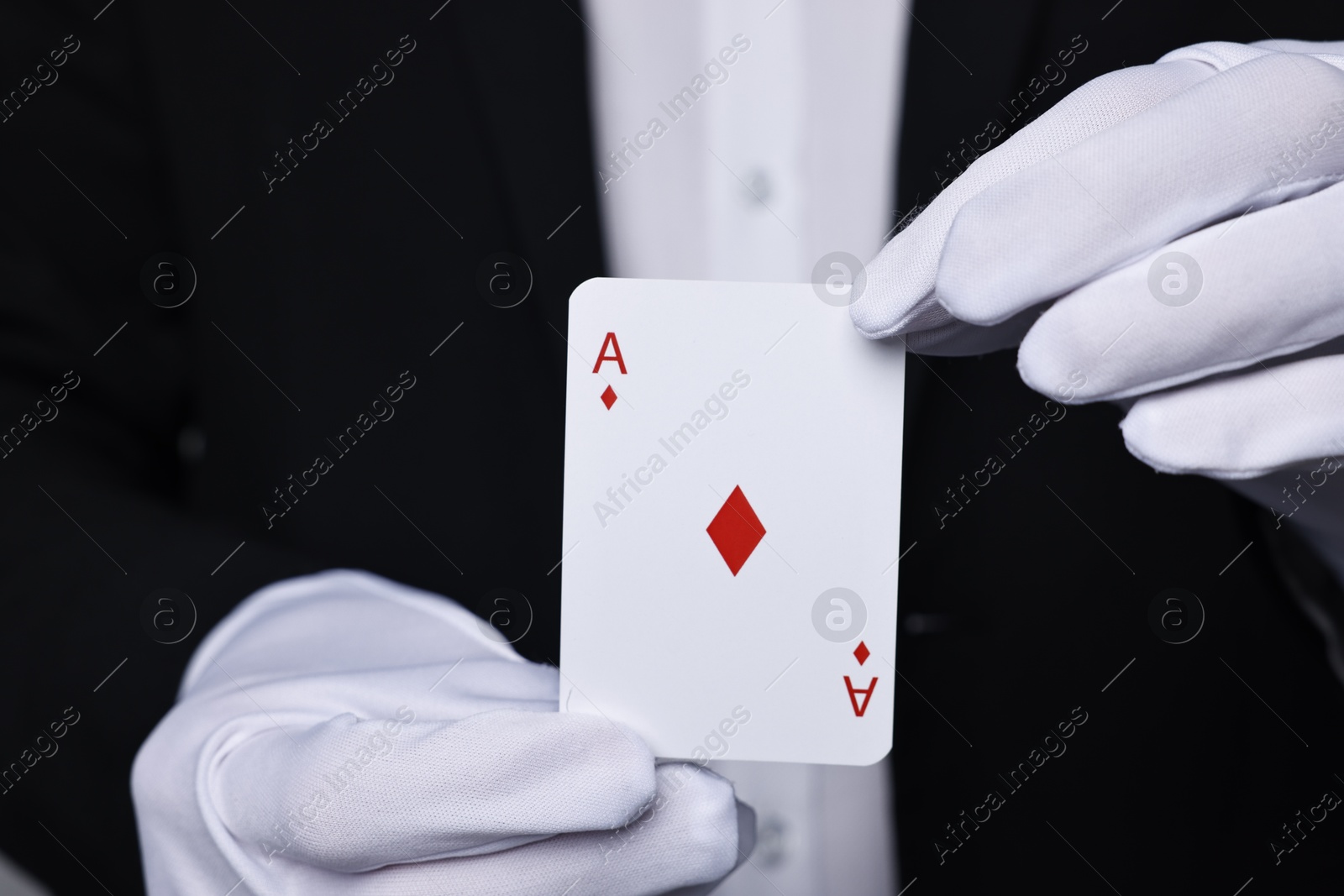 Photo of Professional illusionist with one playing card, closeup