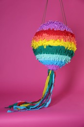 Photo of One colorful pinata on bright pink background