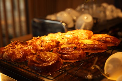 Photo of Delicious sweet roll buns on display in cafe, closeup