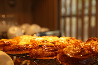 Photo of Delicious sweet roll buns on display in cafe, closeup