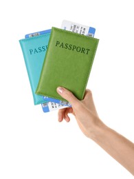 Photo of Woman holding passports with tickets on white background, closeup