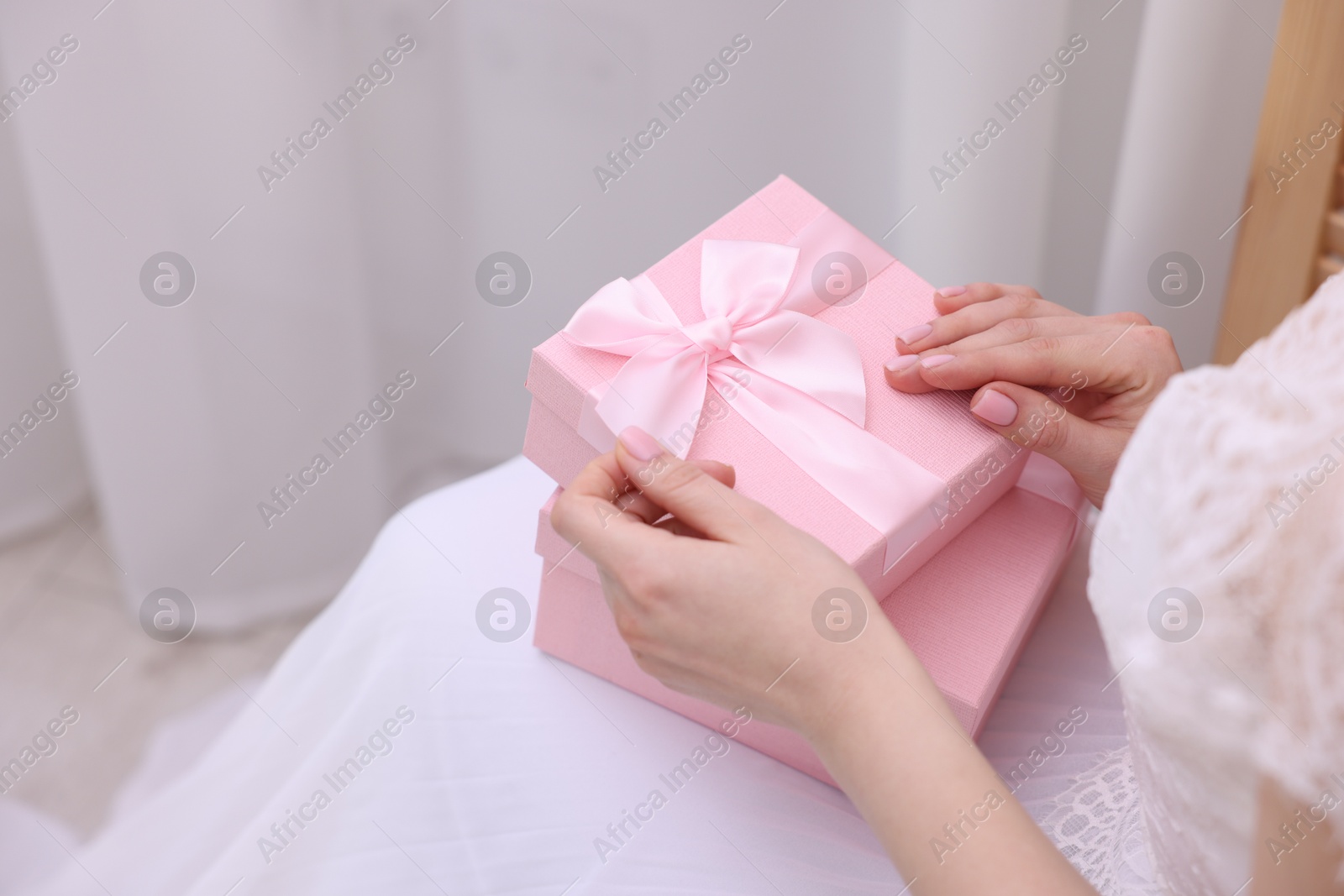 Photo of Bride with beautiful wedding gifts indoors, closeup. Space for text