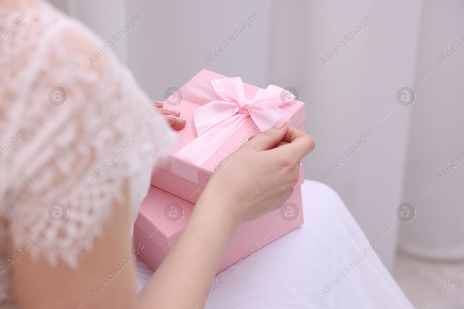 Photo of Bride with beautiful wedding gifts indoors, closeup. Space for text