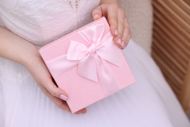 Photo of Bride with beautiful wedding gift indoors, closeup. Space for text