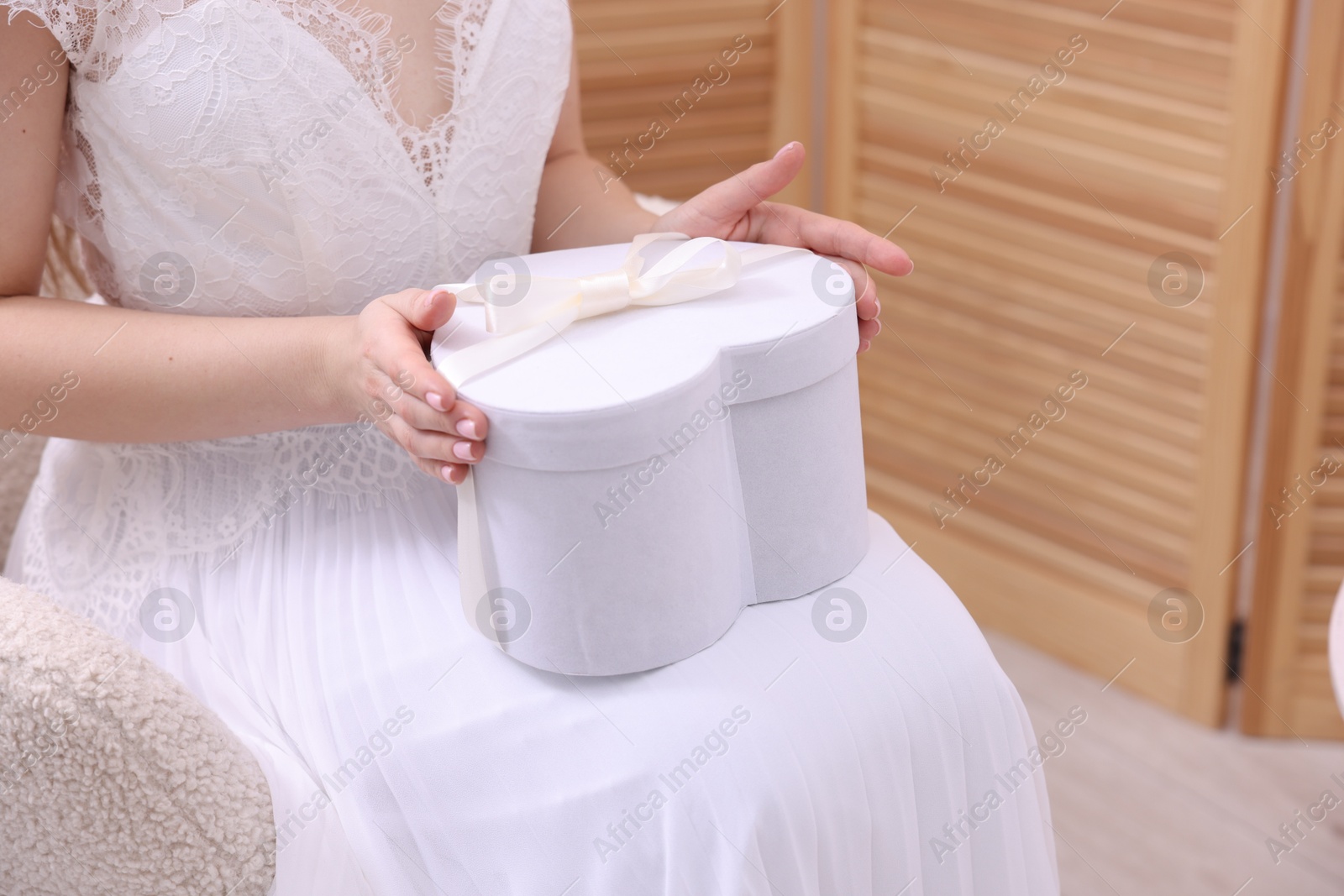 Photo of Bride with beautiful wedding gift indoors, closeup. Space for text