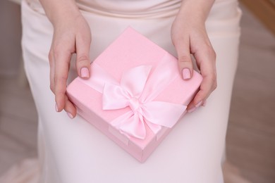 Photo of Bride with beautiful wedding gift indoors, above view