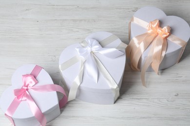 Photo of Beautiful wedding gifts on light wooden table, above view