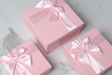 Photo of Beautiful wedding gifts on white marble table, above view