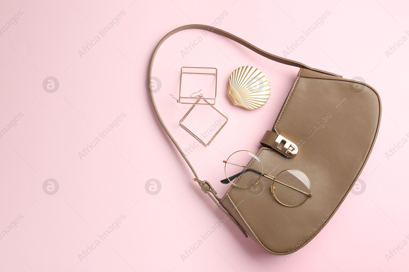 Photo of Beautiful bag and stylish accessories on pink background, flat lay. Space for text