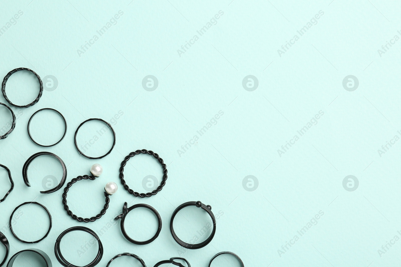 Photo of Stylish accessories on light blue background, flat lay. Space for text