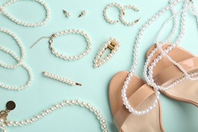 Photo of Stylish accessories and shoes on light blue background, flat lay