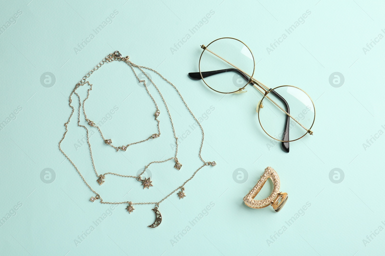 Photo of Stylish accessories on light blue background, flat lay