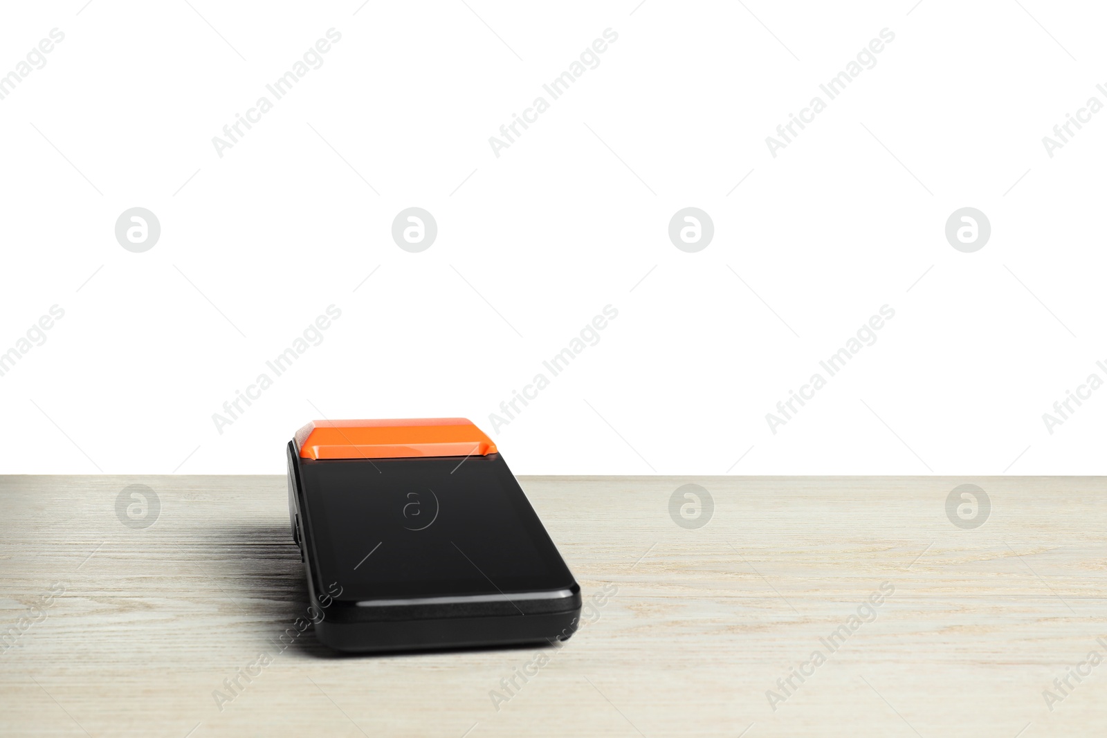 Photo of Payment terminal on wooden table against white background