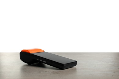 Photo of Payment terminal on grey table against white background