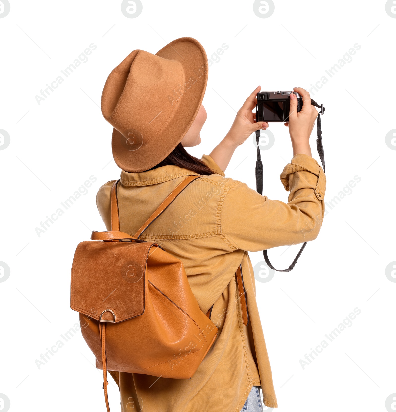 Photo of Traveller with backpack taking photo on white background, back view