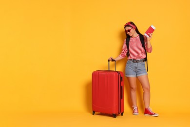 Photo of Traveller with passport and suitcase on yellow background. Space for text