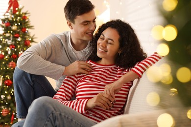 Photo of Happy couple spending time together at home. Christmas celebration