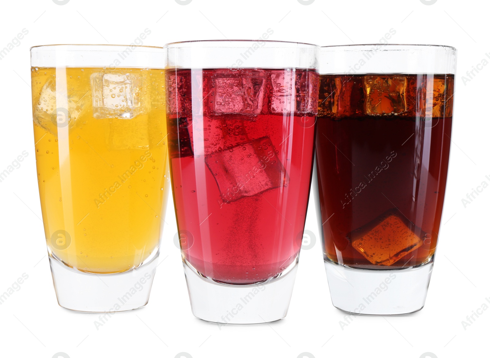 Photo of Soda water of different flavors with ice cubes in glasses isolated on white