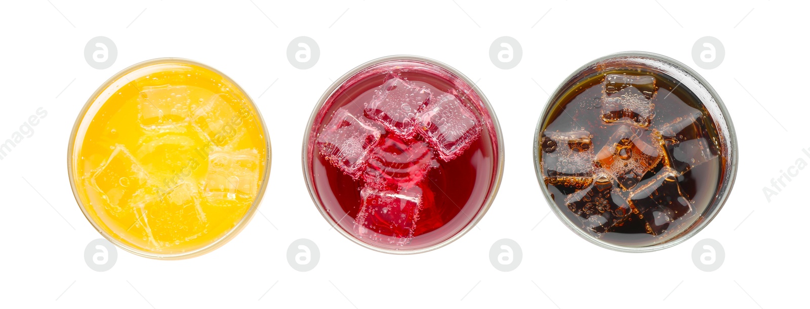 Photo of Soda water of different flavors with ice cubes in glasses isolated on white, top view