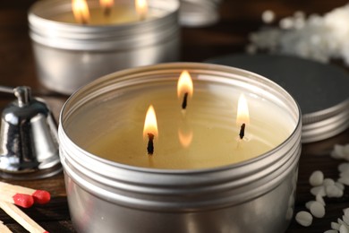 Photo of Burning soy wax candles on table, closeup