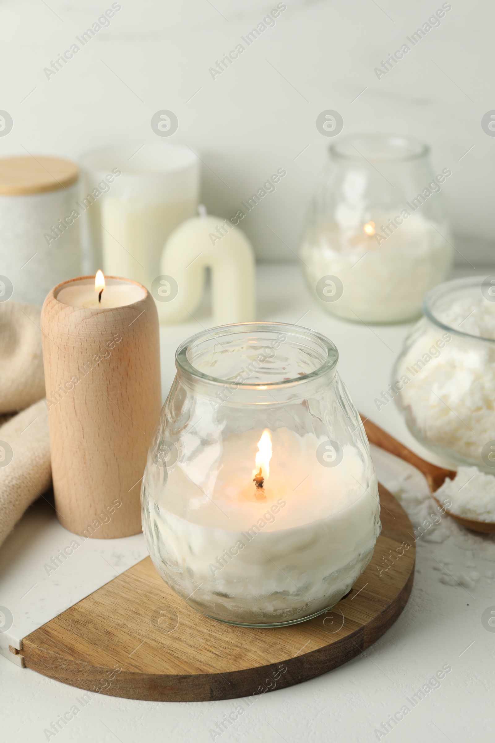 Photo of Burning soy wax candles on light table