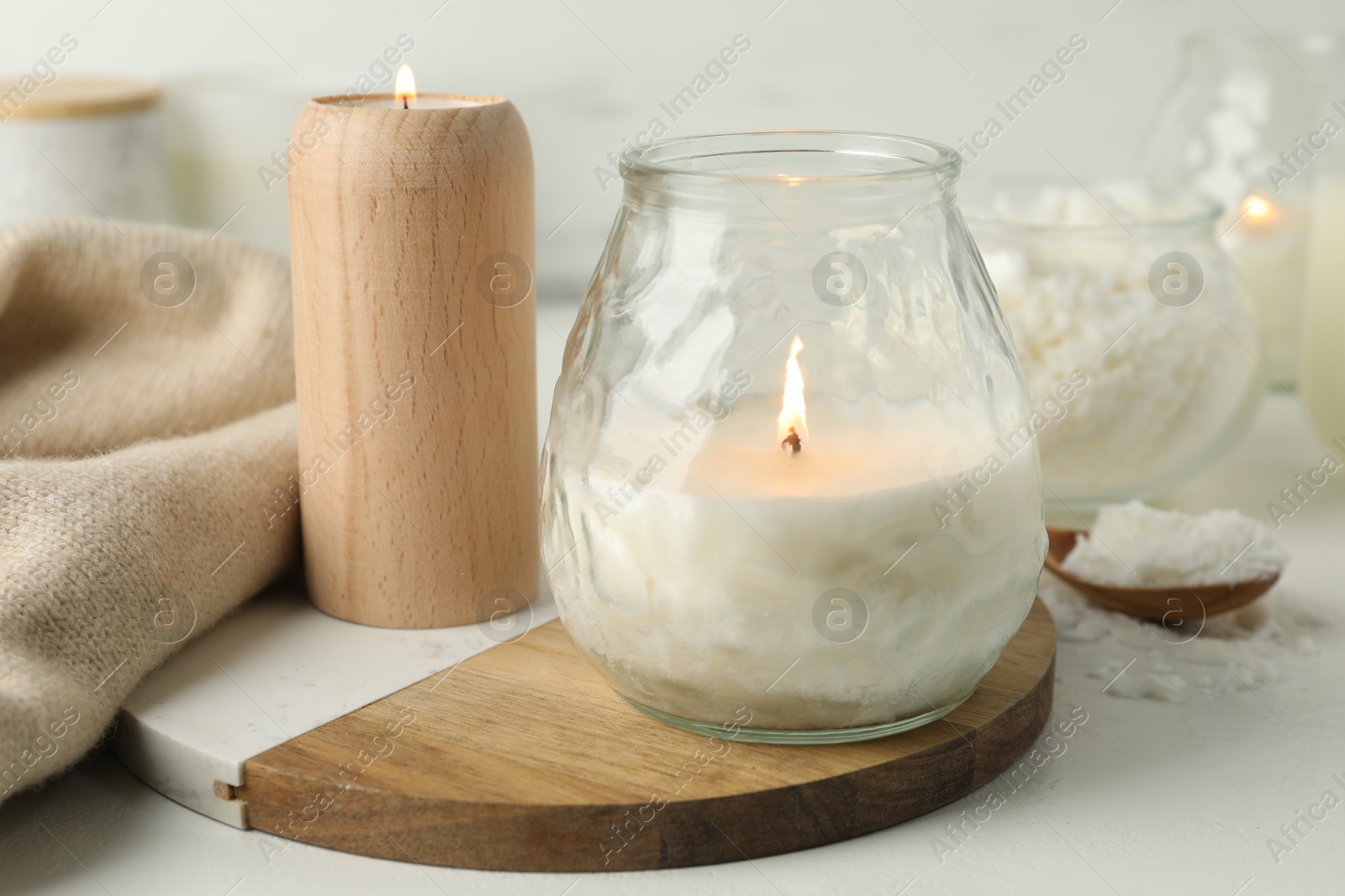 Photo of Burning soy wax candles on light table, closeup