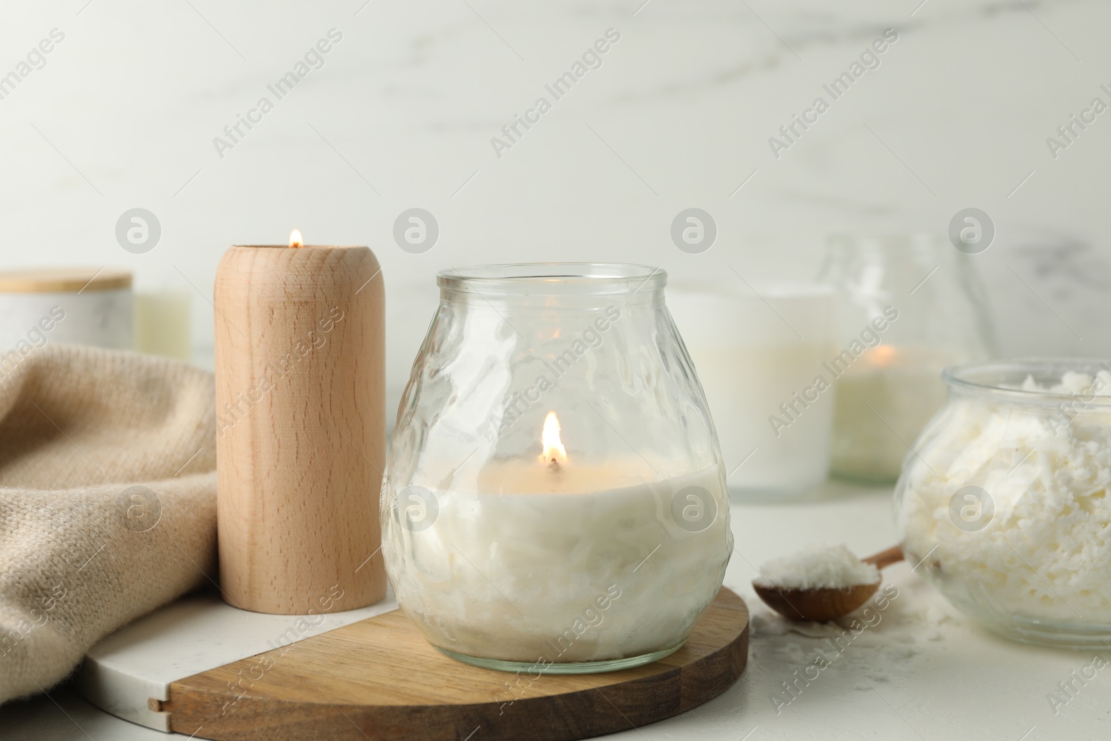 Photo of Burning soy wax candles on light table