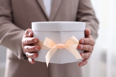 Groom with beautiful wedding gift indoors, closeup